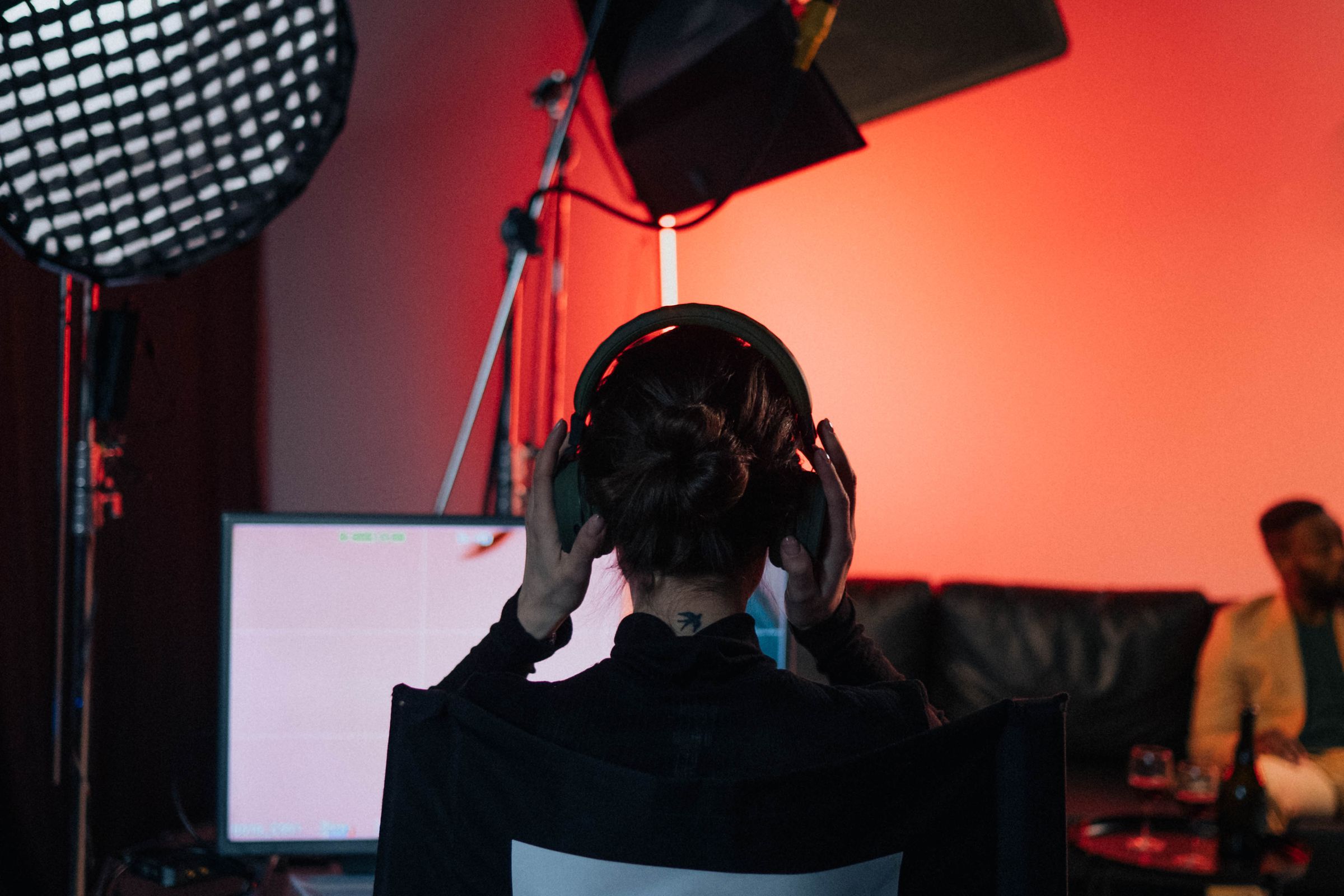 A film director in a chair wearing headphones.